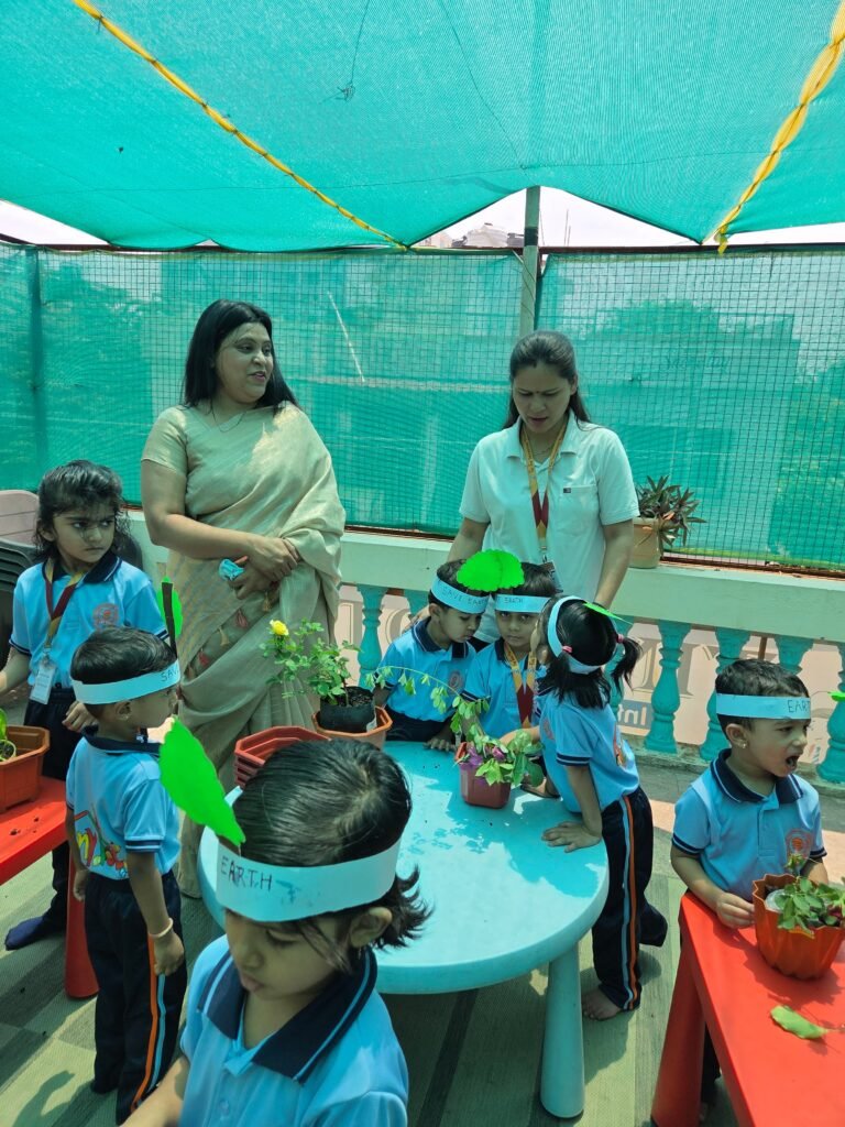 Tiny Tots children and teachers with potted plants on Earth Day