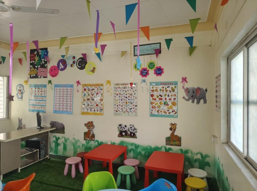 A Tiny Tots classroom, with bunting across the ceiling, charts on the walls and small tables and chairs