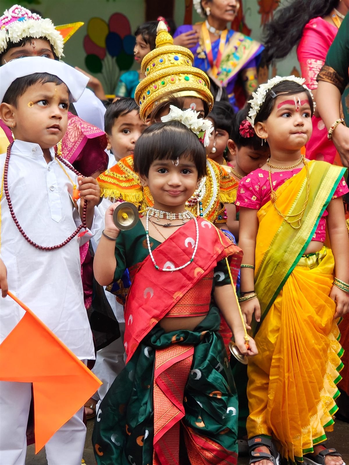 Children dressed as warkaris, Vitthal and Rukmini with cymbals and saffron flags at the Tiny Tots Ashadhi dindi